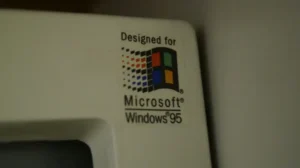 Close-Up Of A “Designed For Microsoft Windows 95” Sticker On Old Computer Hardware
