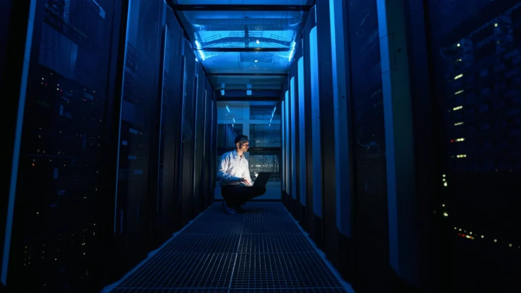 Ai Agents For Small Business: Practical Automation Every Colorado Company Can Use Today 6 It Technician Working Inside A Data Center Aisle Performing Server Maintenance, Infrastructure Monitoring, And System Administration Tasks