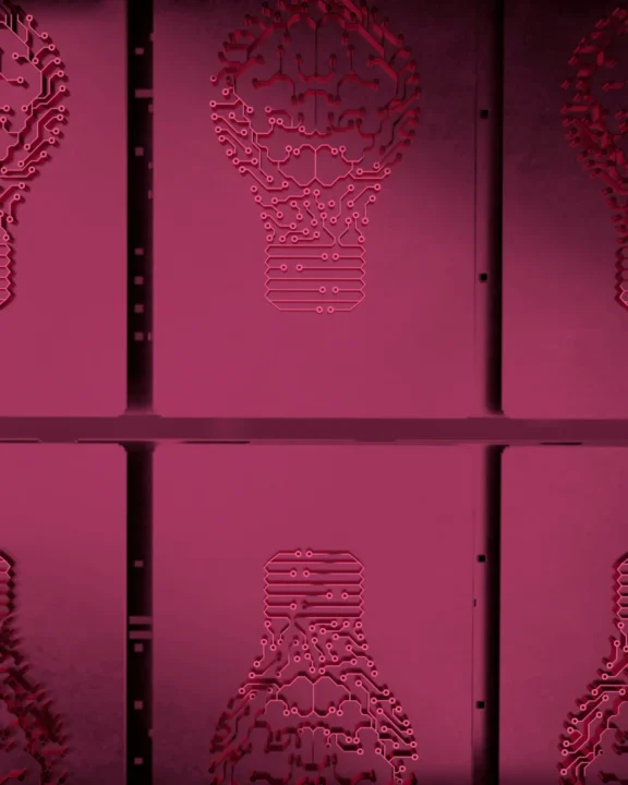 Red Neon Wall Art Shaped Like A Lightbulb Made Of Circuit Board Lines And Electronic Pathways On A Modern Interior Wall.