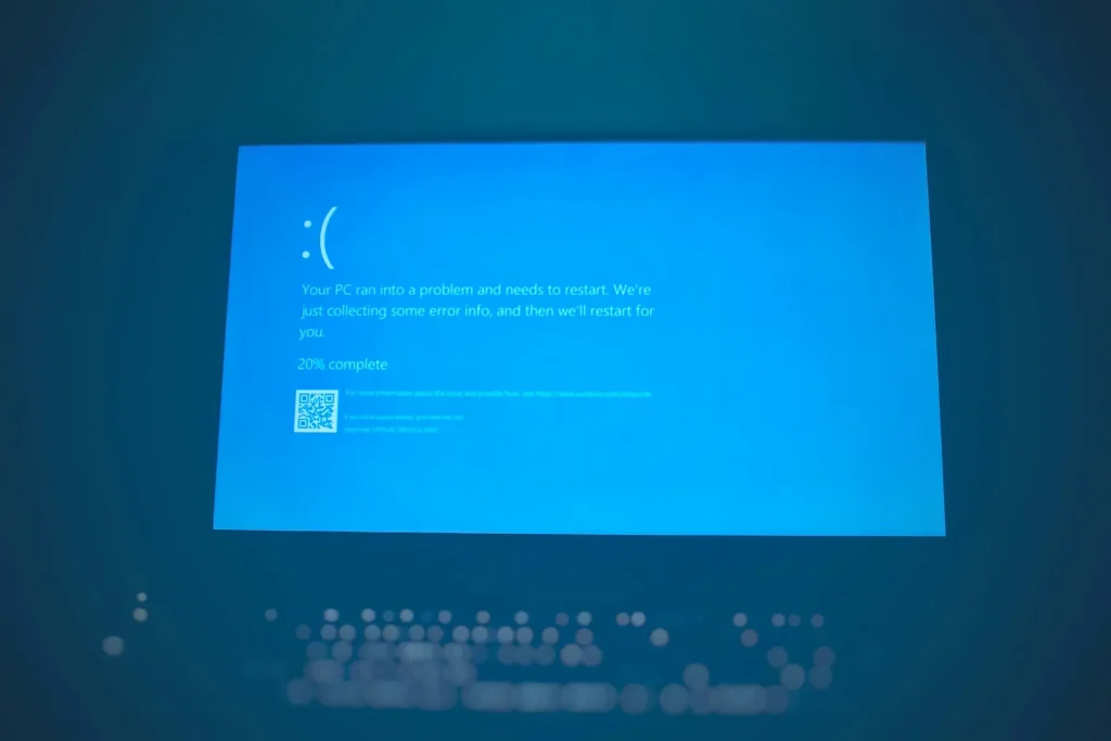 Windows computer displaying blue screen error message with system crash warning.