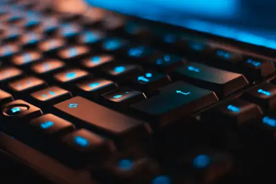 Close-up view of a mechanical keyboard with dark ambient lighting