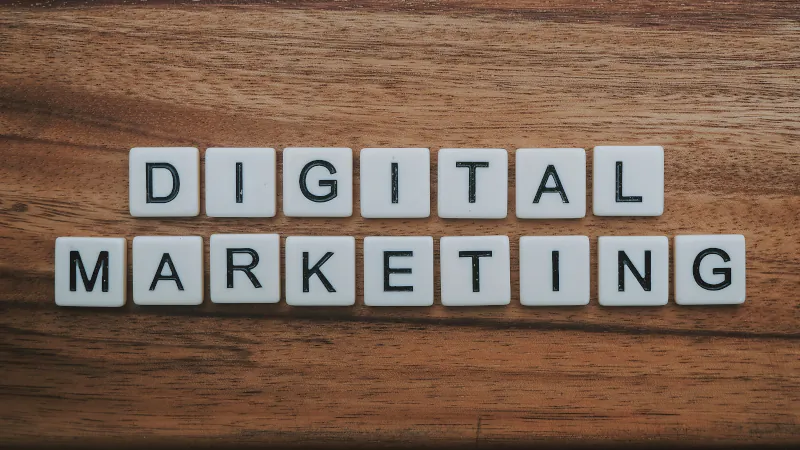 Scrabble-style tiles spelling “Digital Marketing” on a wooden surface with website load speed