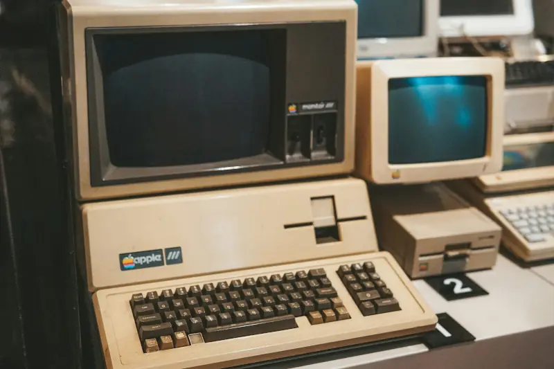 A vintage Apple III computer with monitor, keyboard, and floppy disk drive