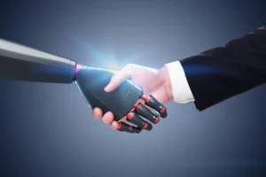 Close-Up Of A Human Hand Shaking Hands With A Robotic Hand, Symbolizing Artificial Intelligence, Trust, And Collaboration Between Humans And Technology.