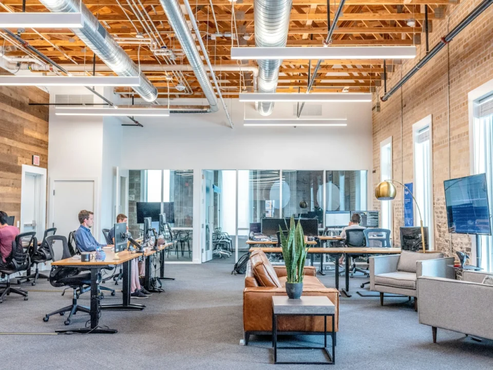 Small Business Server: What Is Better For Your Business? Physical Onsite Server Vs Cloud Offsite Server. 7 Open Office With Employees Working At Computers In A Modern Small Business Workspace