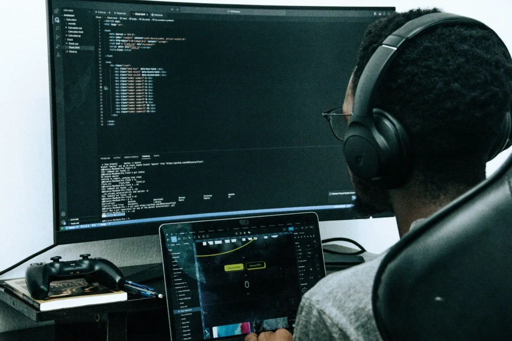 Top 5 Crm For Small Business To Improve Sales &Amp; Growth 3 Developer Wearing Headphones Coding With A Laptop And External Monitor.